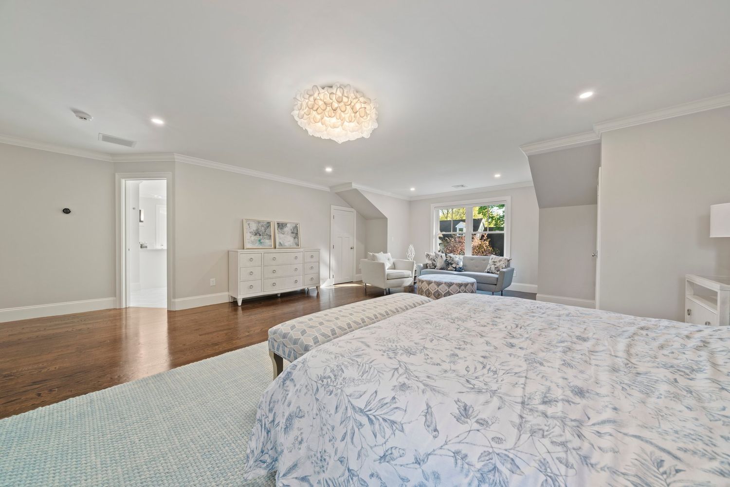 a front view of a house with a yard and potted plants