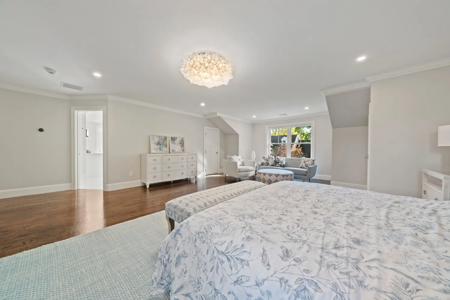 a front view of a house with a yard and potted plants