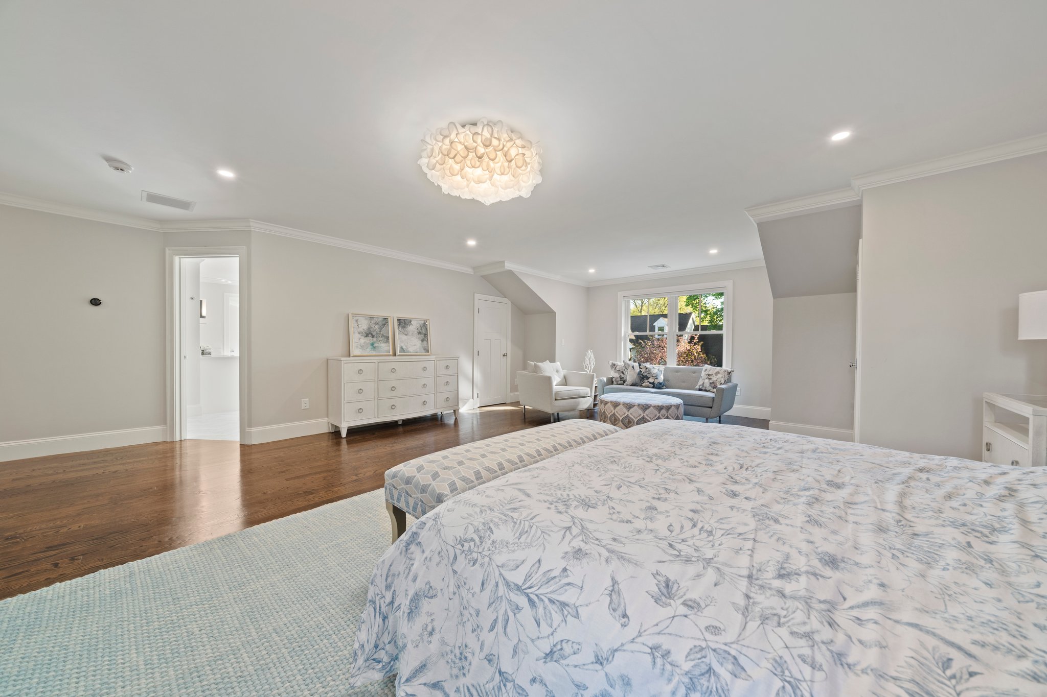 241 Lowell Road Wellesley, MA 02481 - Photo 38 of 85 a spacious bedroom with a large bed and a chandelier