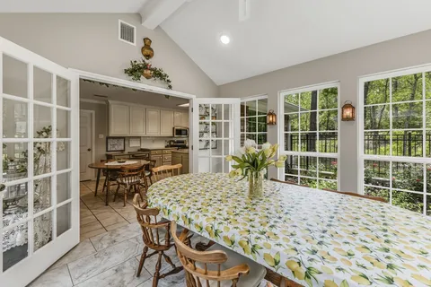 a dining room with furniture and window