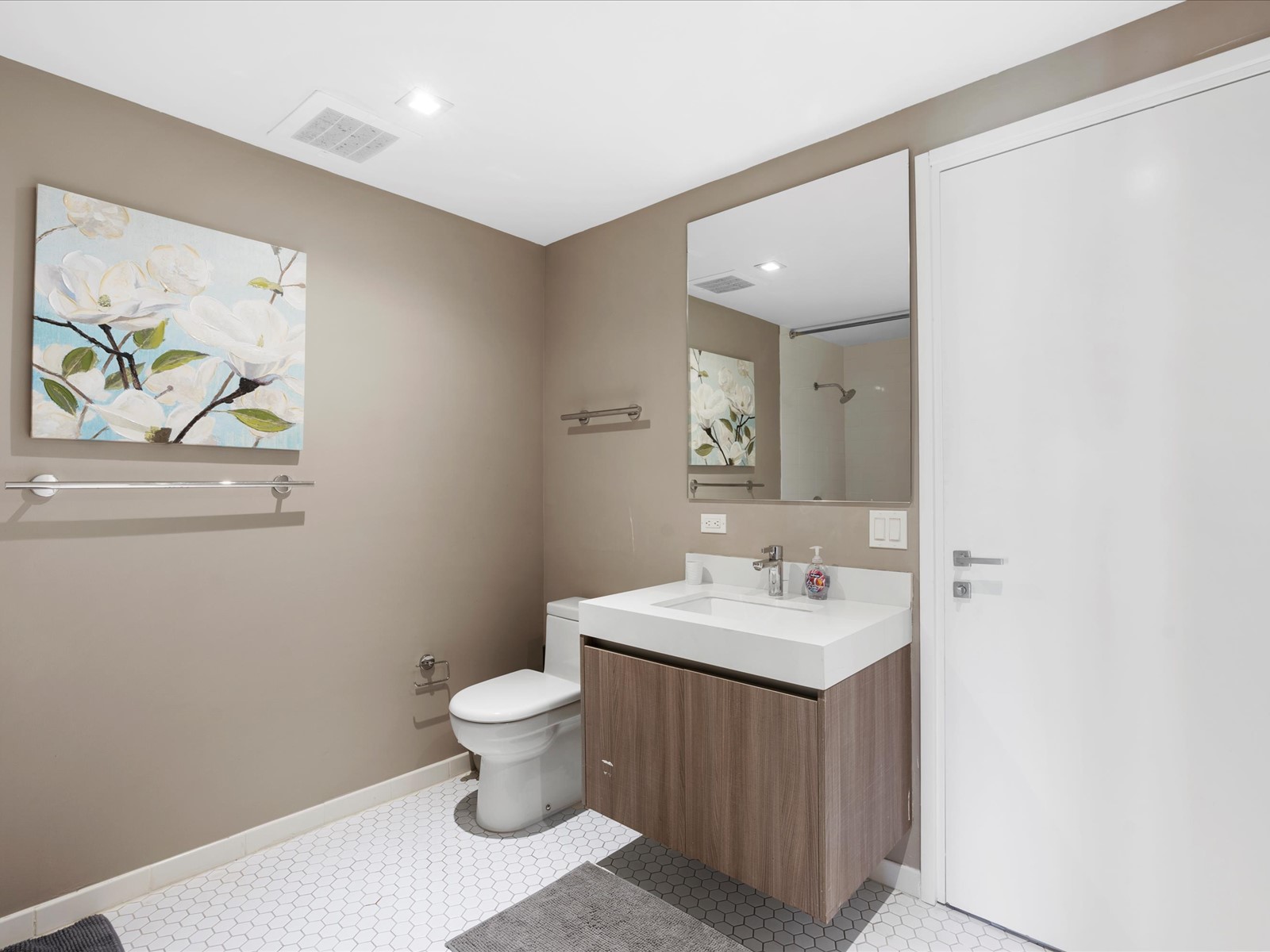 401 North Birch Road, Unit 603 Fort Lauderdale, FL 33304 - Photo 14 of 16 a bathroom with a sink a toilet and a mirror