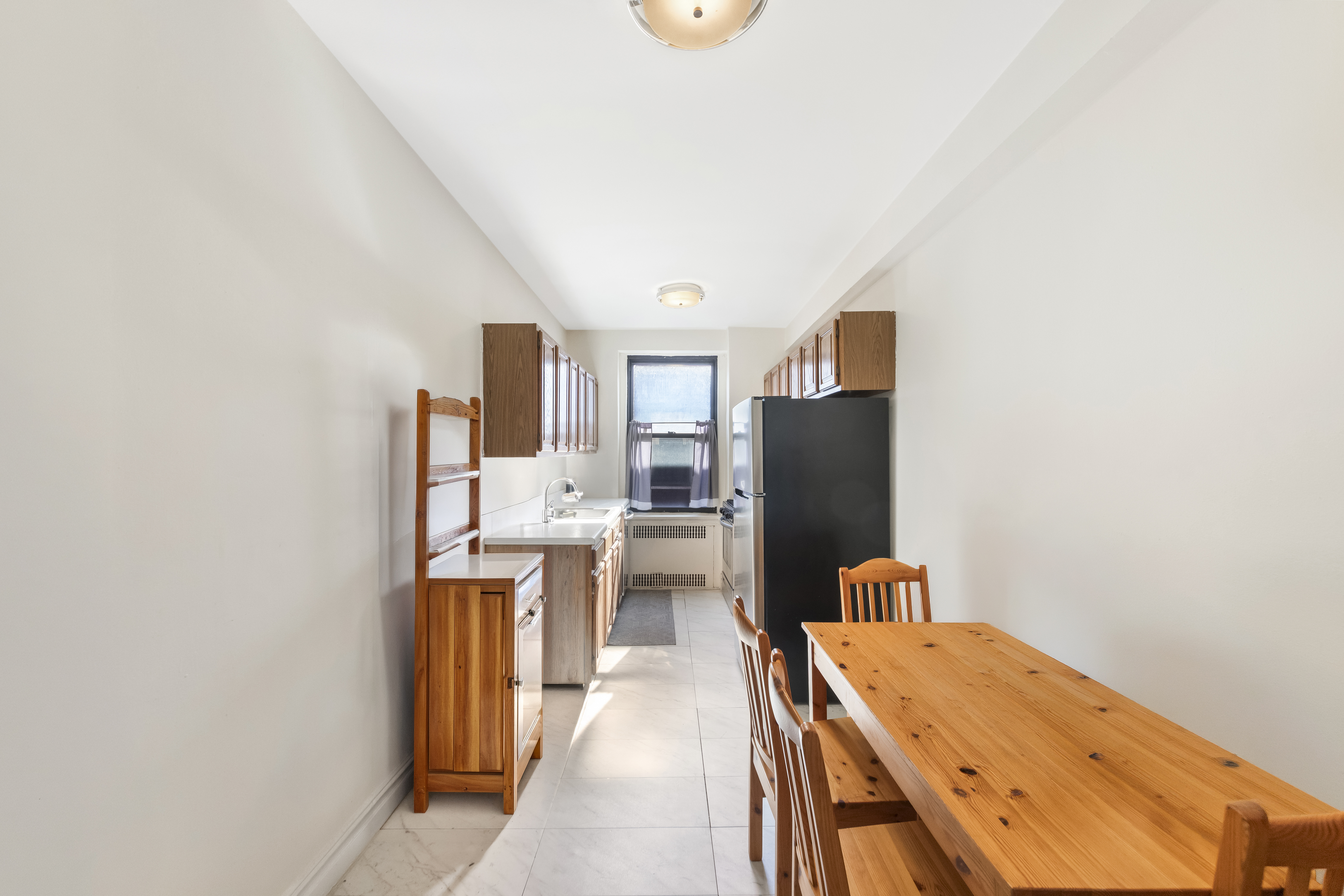 3220 Avenue H, Unit 6N Brooklyn, NY 11210 - Photo 3 of 9 a dining hall with stainless steel appliances granite countertop a refrigerator and a stove top oven