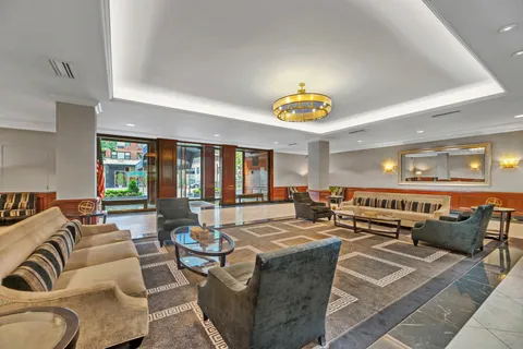 a living room with lots of furniture and painting on the wall