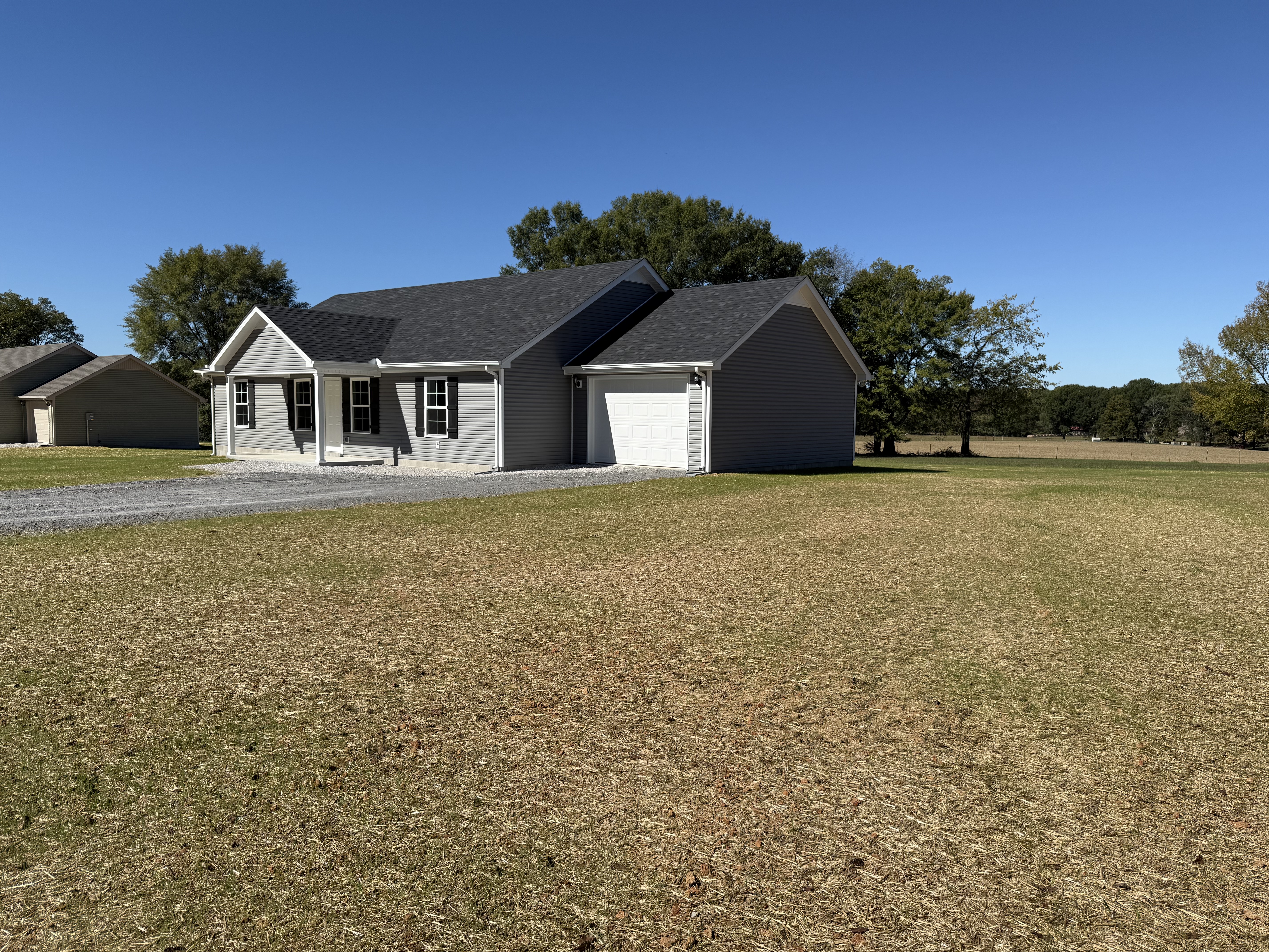 543 Paynes Church Road Estill Springs, TN 37330 - Photo 3 of 33 a front view of a house with a yard and garage
