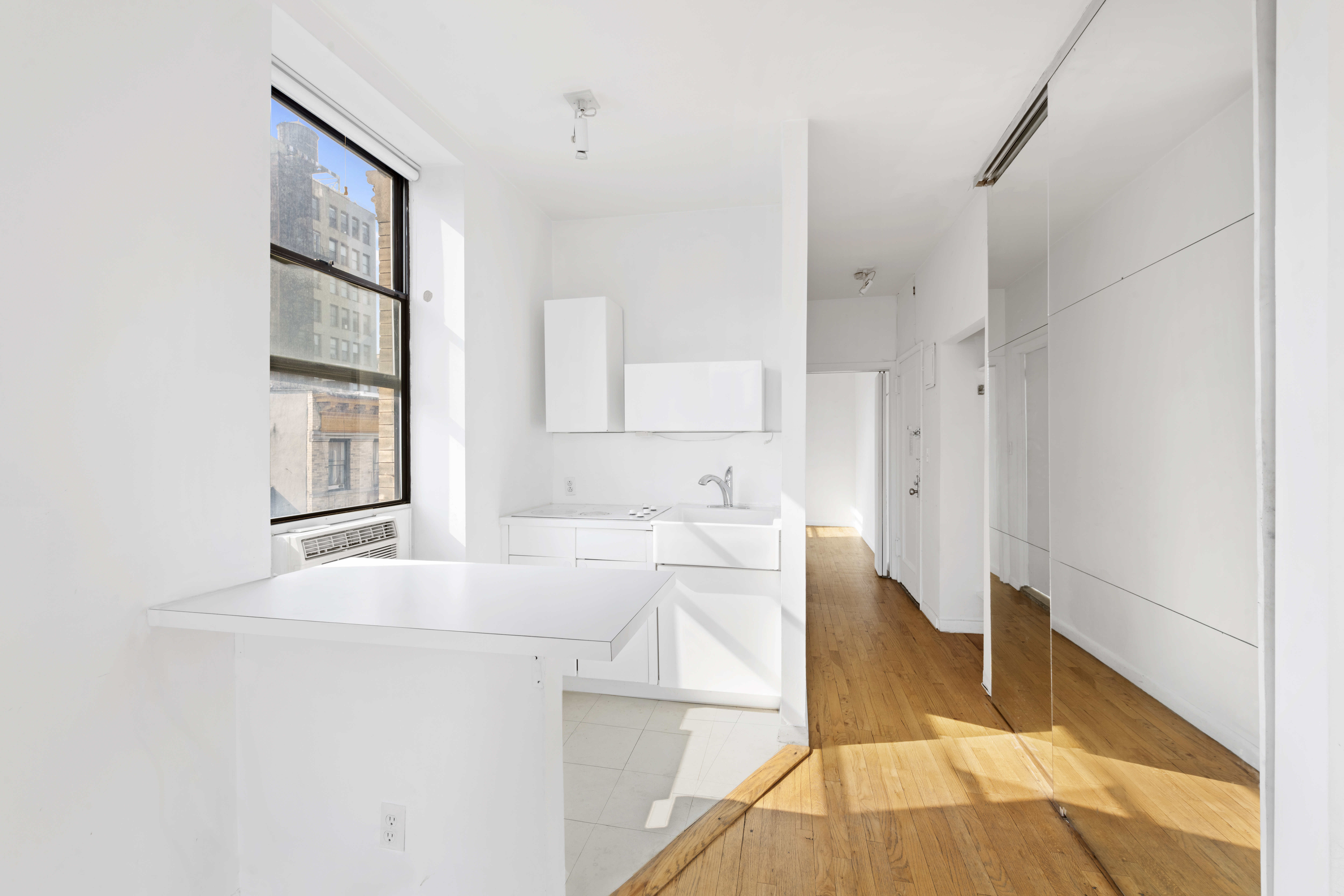 214 Mulberry Street, Unit 6B Manhattan, NY 10012 - Photo 6 of 12 a kitchen with granite countertop a stove a sink and a refrigerator