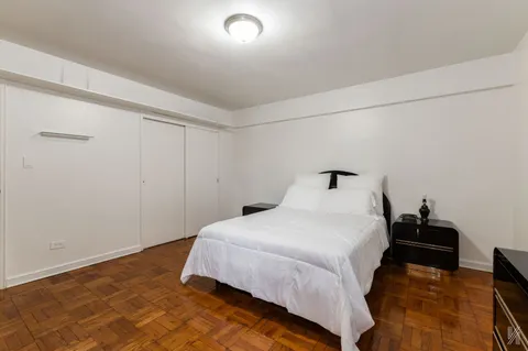 a bedroom with a bed and a night stand