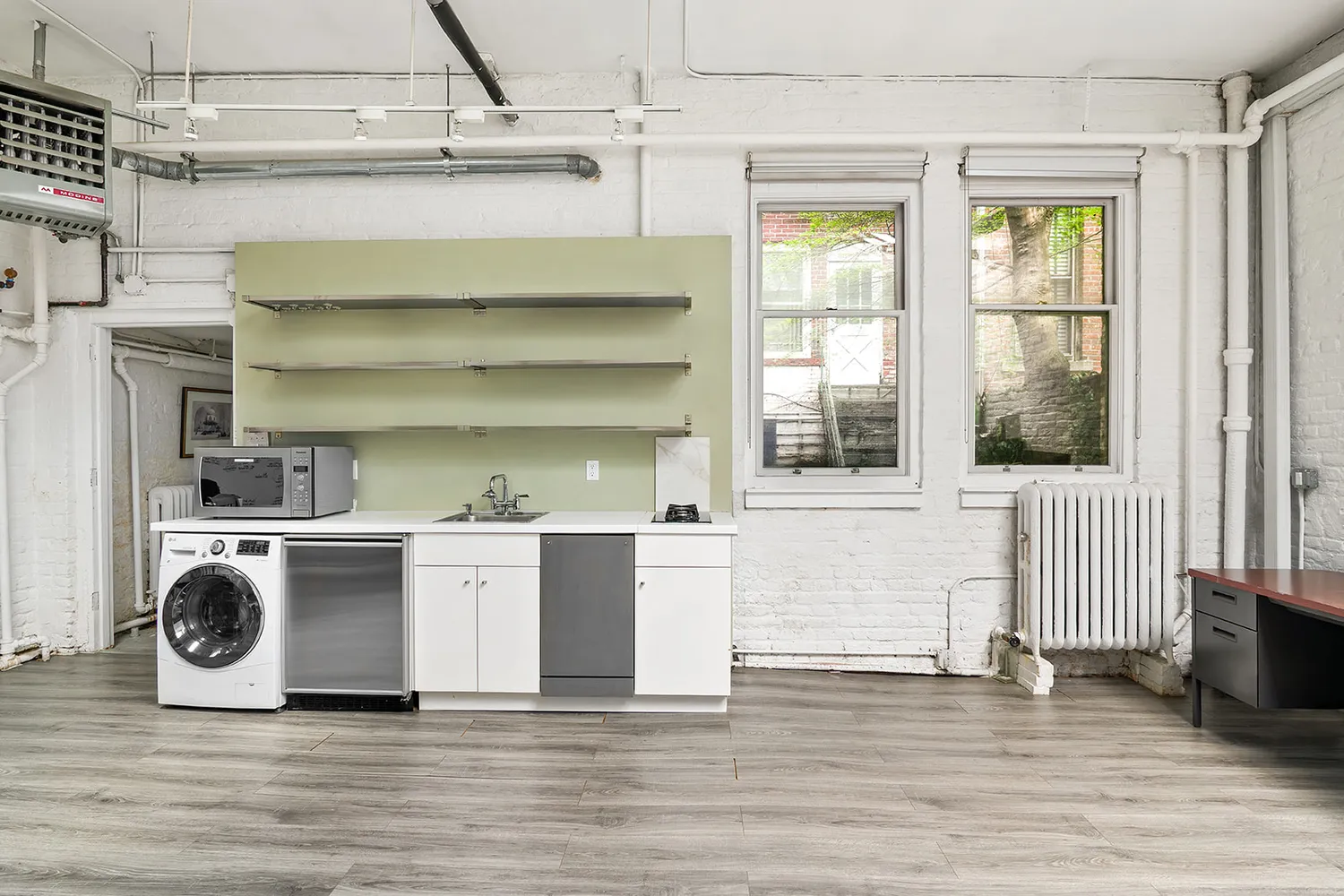 a kitchen with a stove and white cabinets