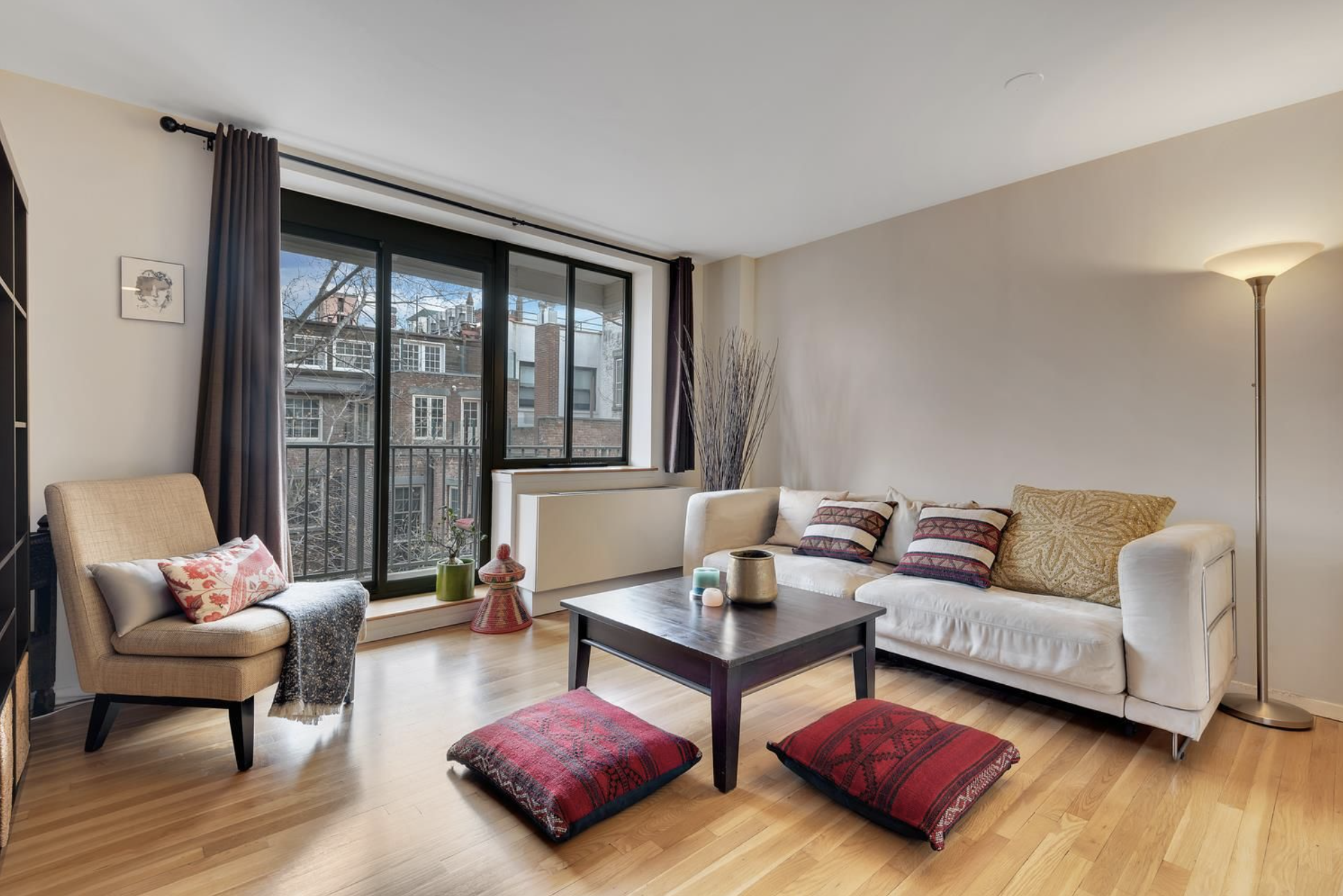 445 West 19th Street, Unit 5G Manhattan, NY 10011 - Photo 1 of 7 a living room with furniture and a large window