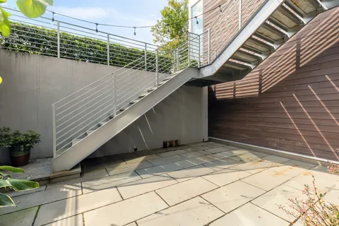 a view of a backyard with a chair and wooden floor