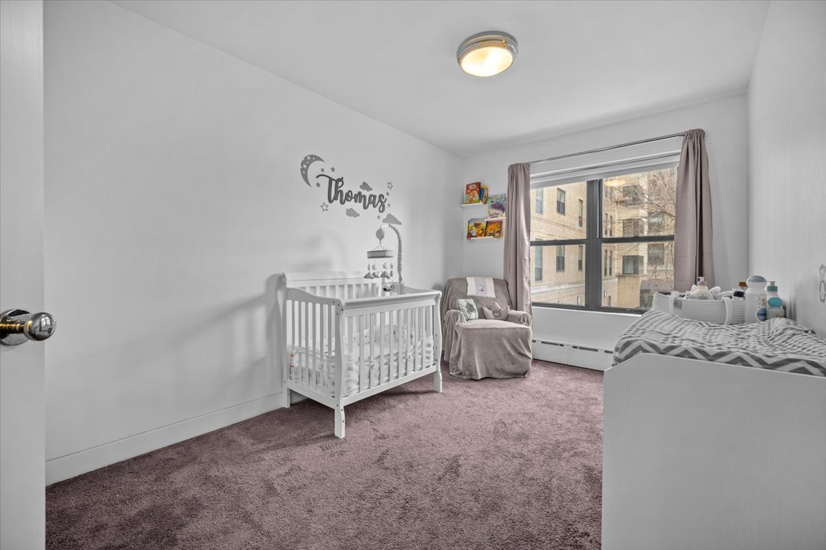 1477 Prospect Place, Unit 2 Brooklyn, NY 11213 - Photo 6 of 14 a bedroom with furniture and a large window