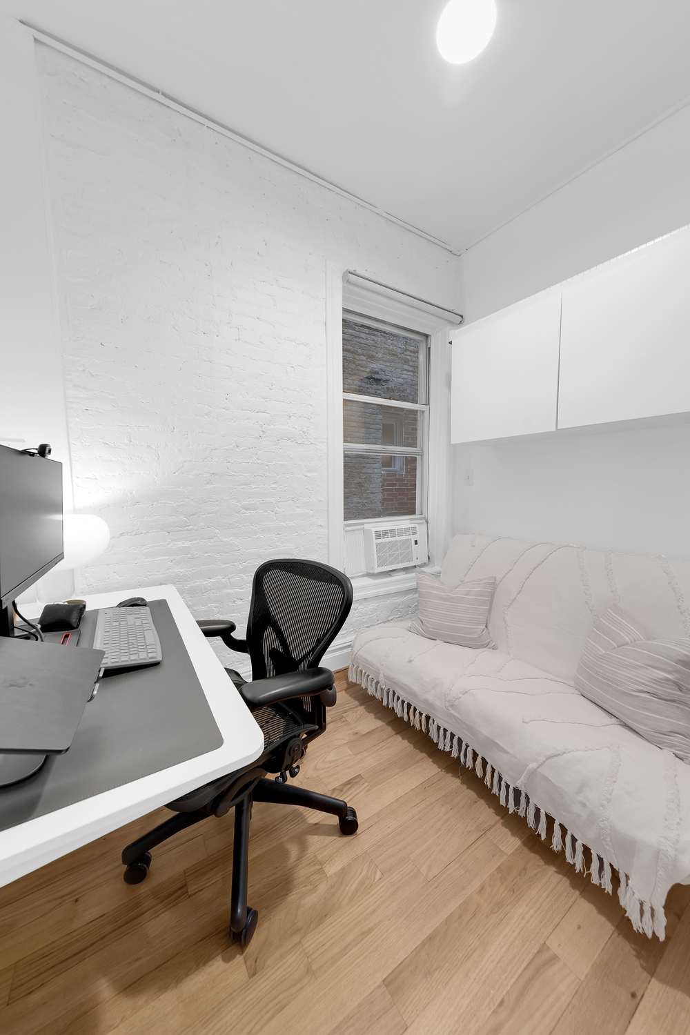 323 West 11th Street, Unit 2WE Manhattan, NY 10014 - Photo 8 of 11 a workspace with furniture and a window