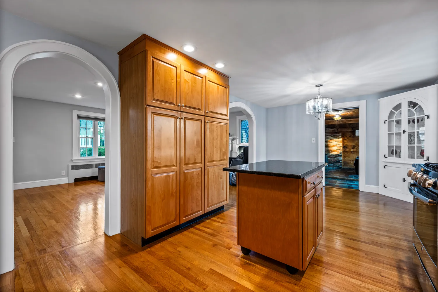 a view of a living room with wooden floor and a window