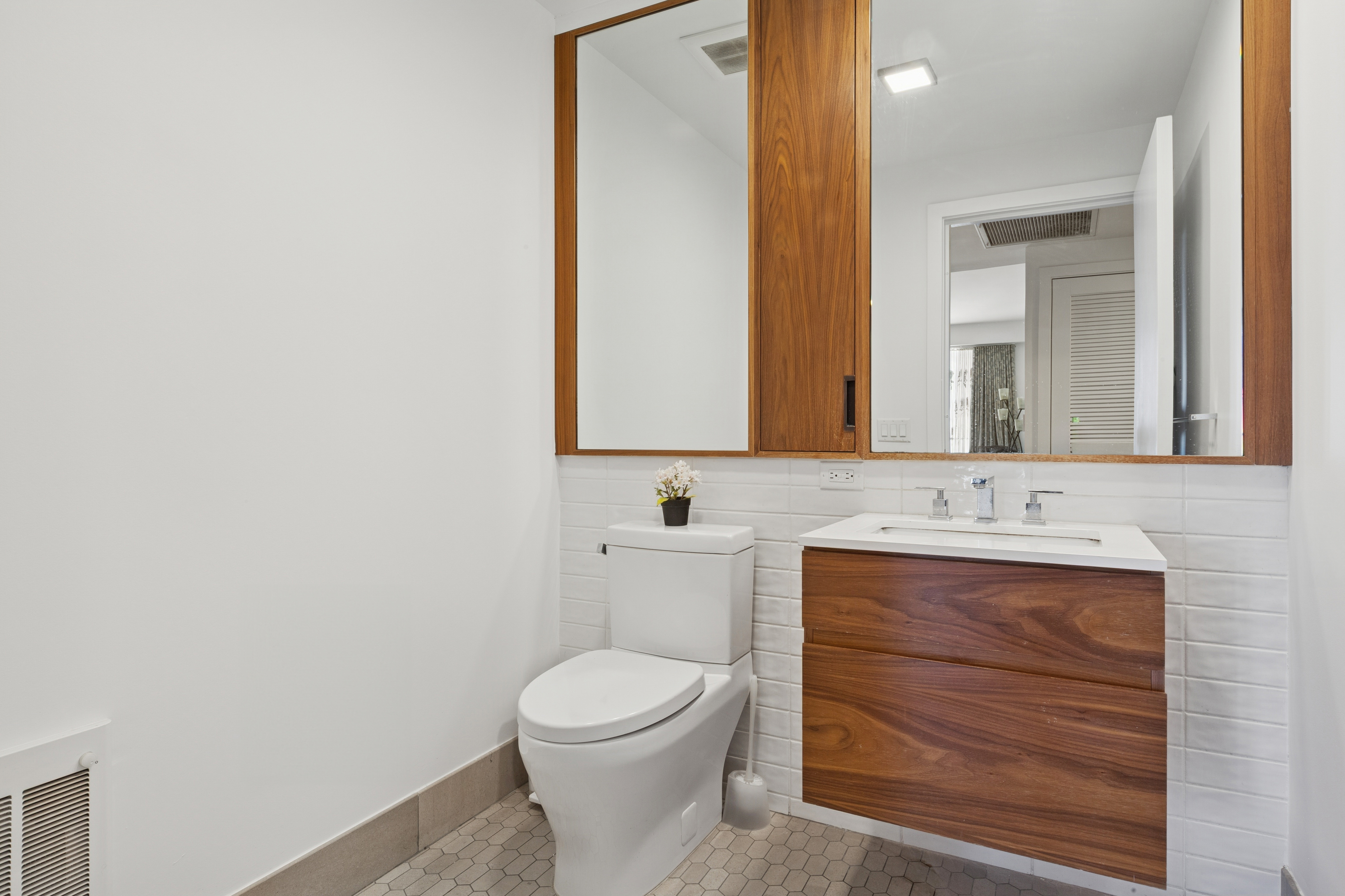 319 Schermerhorn Street, Unit 19B Brooklyn, NY 11217 - Photo 10 of 13 a bathroom with a toilet sink and mirror
