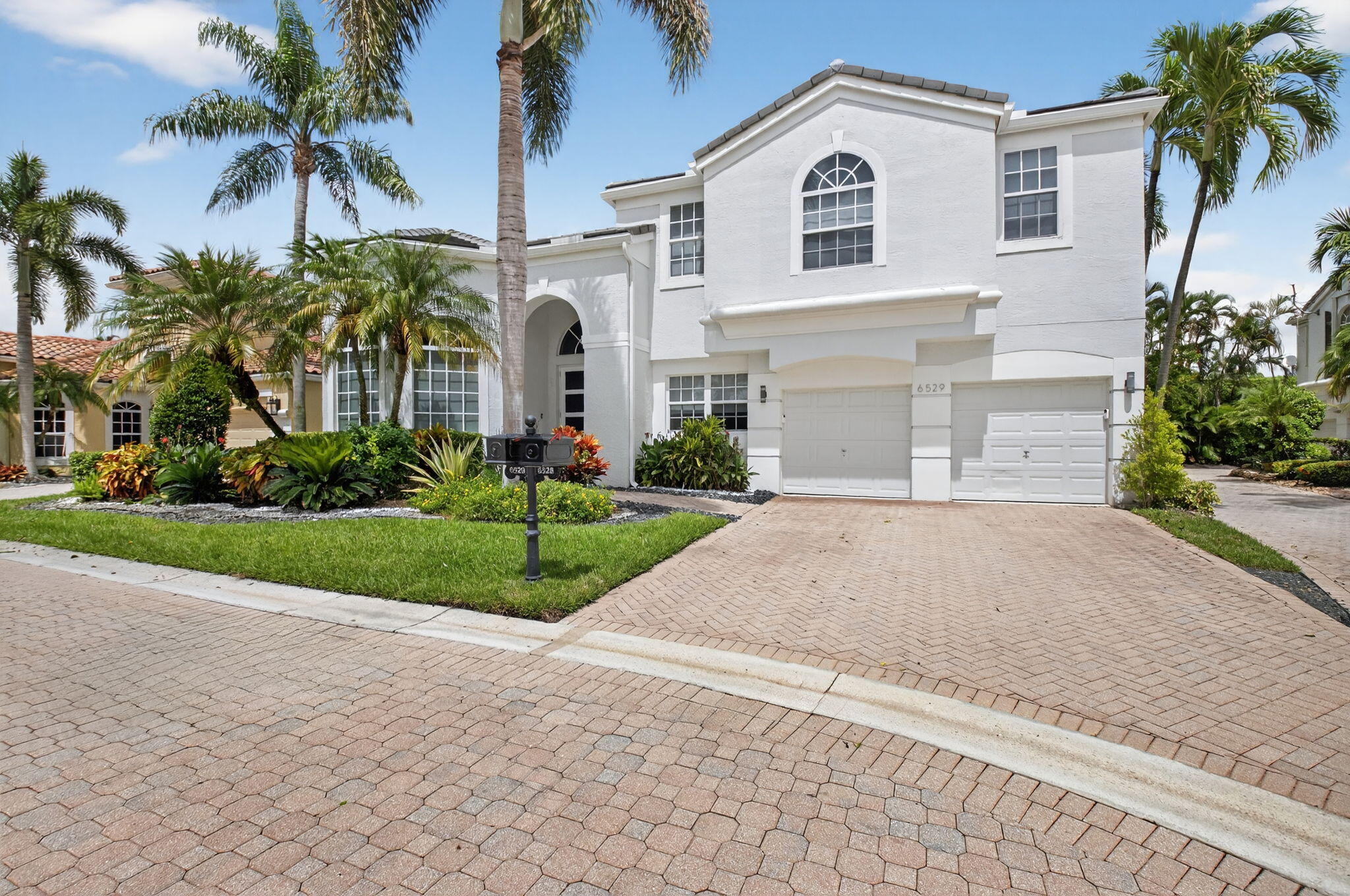 6529 Somerset Circle Boca Raton, FL 33496 - Photo 4 of 75 a front view of a house with a yard and garage