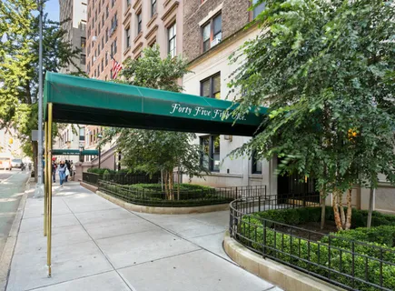 a view of a entrance gate of the house and trees