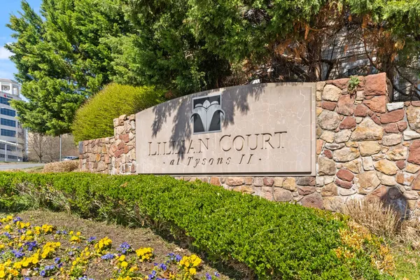 a view of sign board with plants