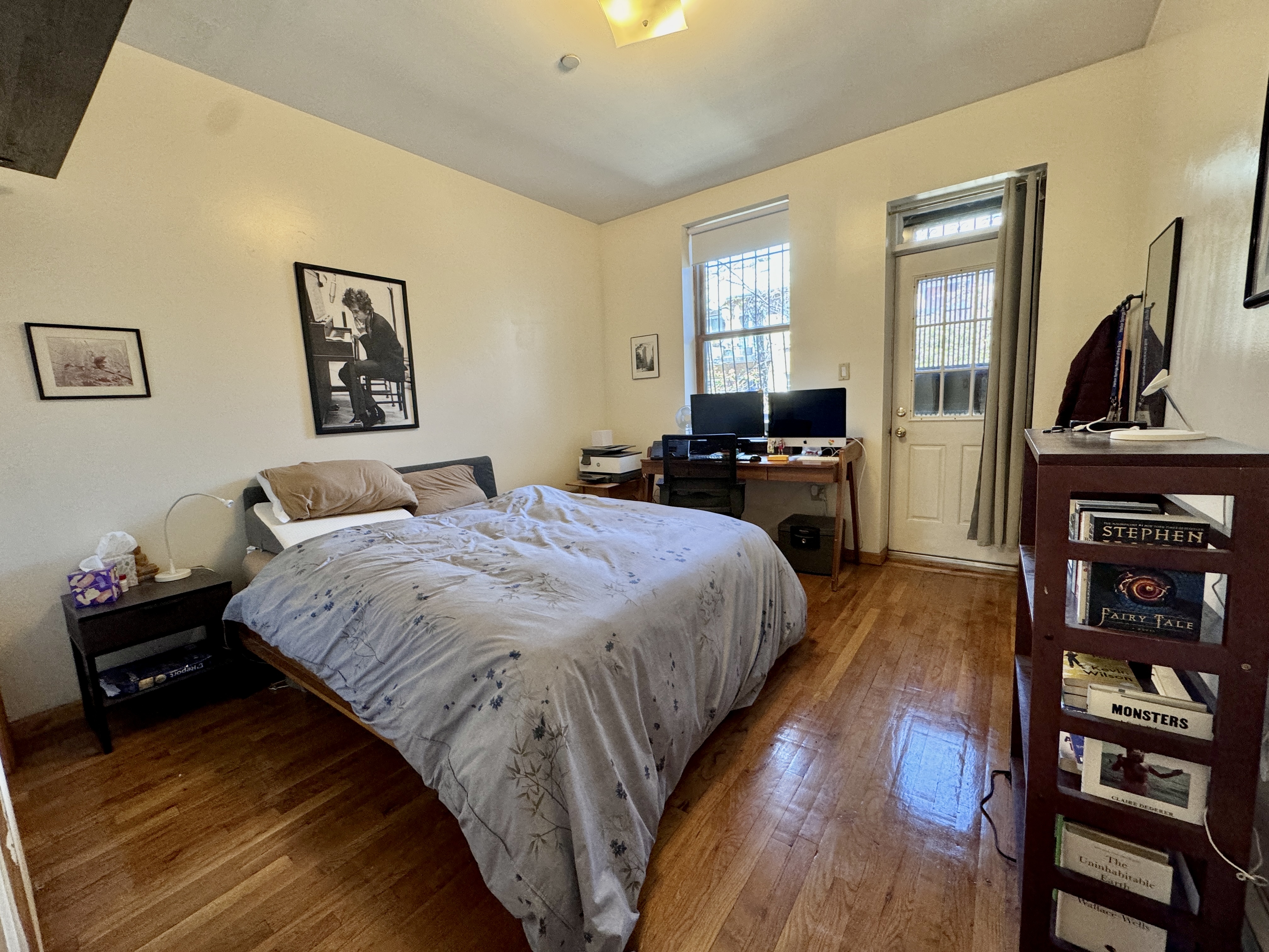 379 Baltic Street, Unit Undisclosed Brooklyn, NY 11201 - Photo 2 of 10 a bedroom with a bed and wooden floor