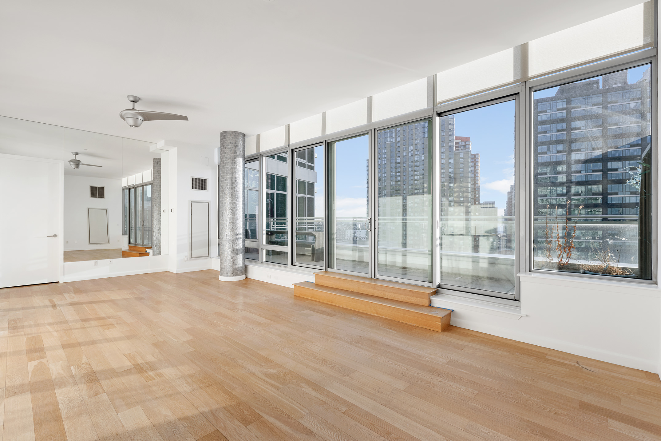 46-30 Center Boulevard, Unit PH8 Queens, NY 11109 - Photo 8 of 32 a view of empty room with floor to ceiling windows