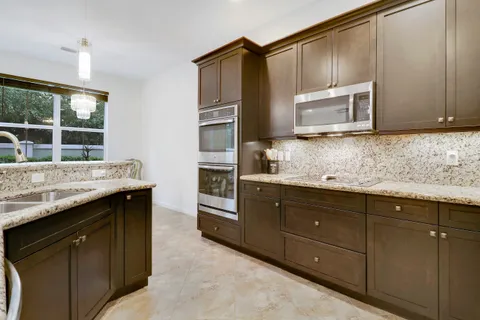 a kitchen with granite countertop cabinets stainless steel appliances and a sink