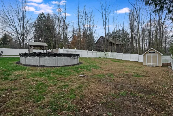 a view of a house with a yard and sitting area