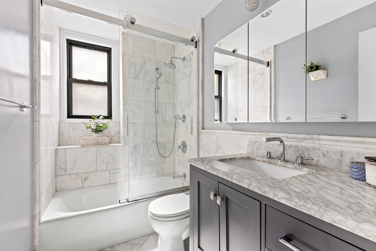 211 East 35th Street, Unit 4D Manhattan, NY 10016 - Photo 5 of 6 a bathroom with a granite countertop sink a toilet and shower