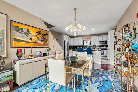 a view of a kitchen with granite countertop stainless steel appliances and wooden floor