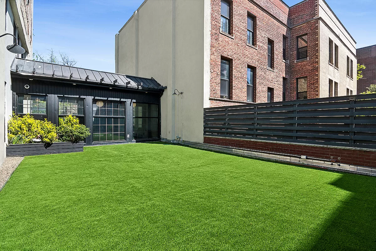 180 Bainbridge Street, Unit 111 Brooklyn, NY 11233 - Photo 17 of 25 a view of a house with garden