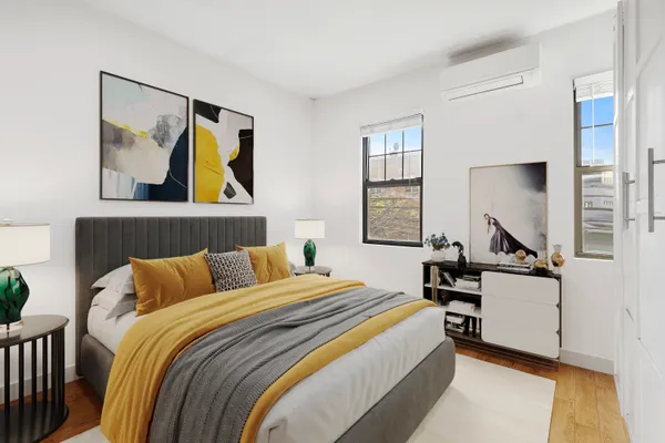 a bedroom with a bed and painting on the wall