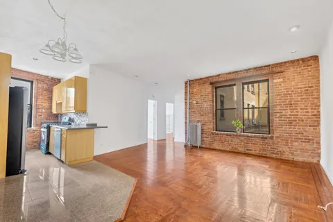 a view of an empty room with a kitchen