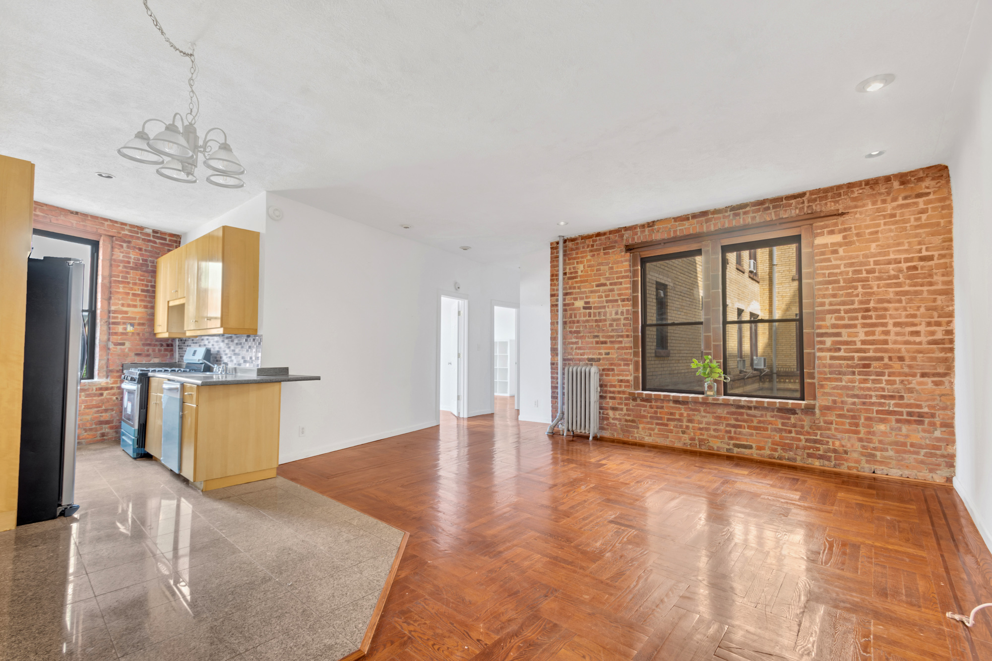 7609 4th Avenue, Unit B1 Brooklyn, NY 11209 - Photo 2 of 17 a view of an empty room with a kitchen