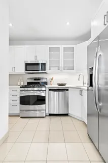 a kitchen with stainless steel appliances a stove a sink and a microwave