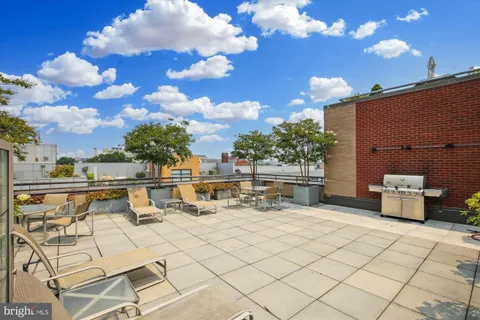 a view of a terrace with furniture and a fire pit