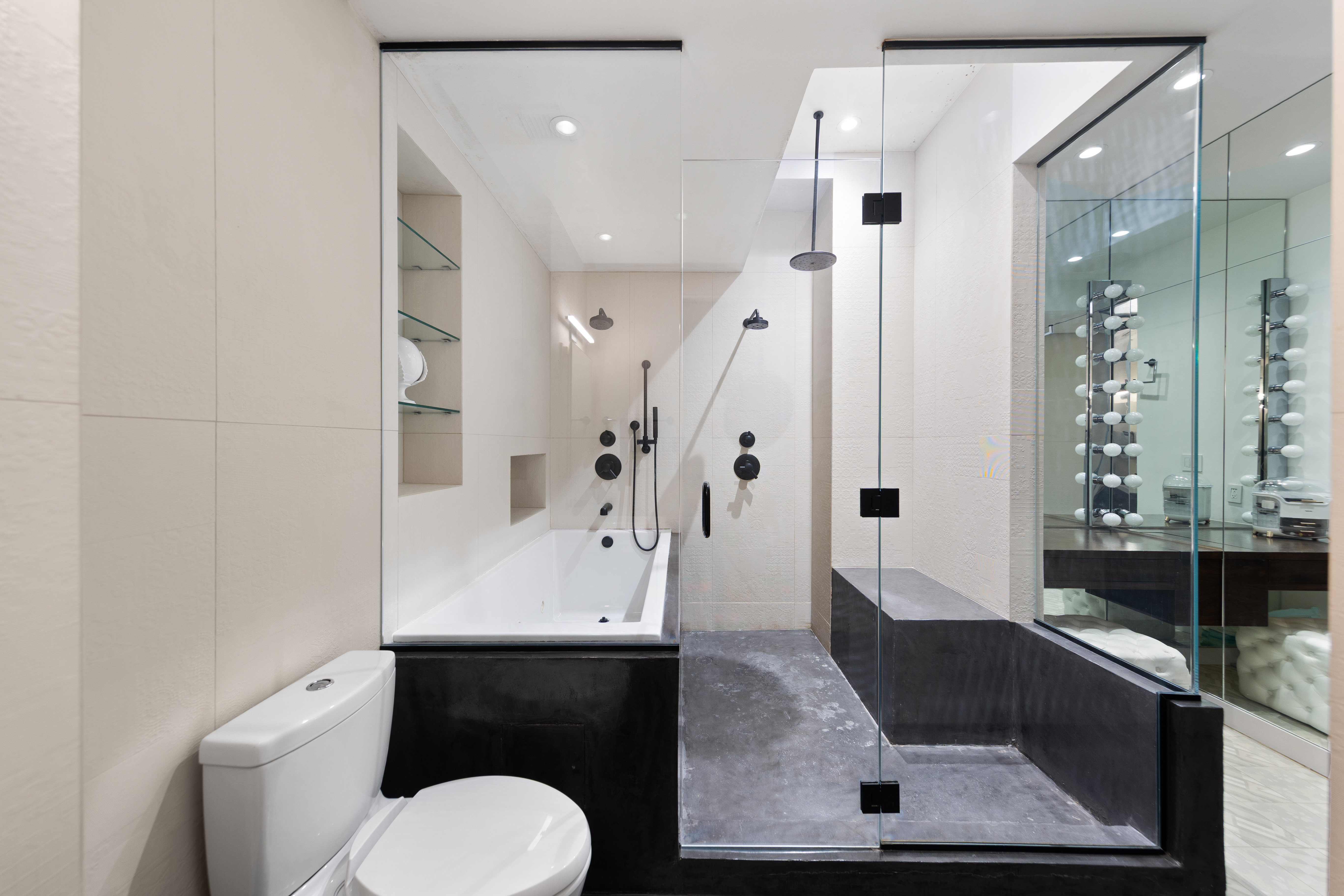 15 Broad Street, Unit 1006 Manhattan, NY 10005 - Photo 13 of 32 a bathroom with a sink a toilet and shower