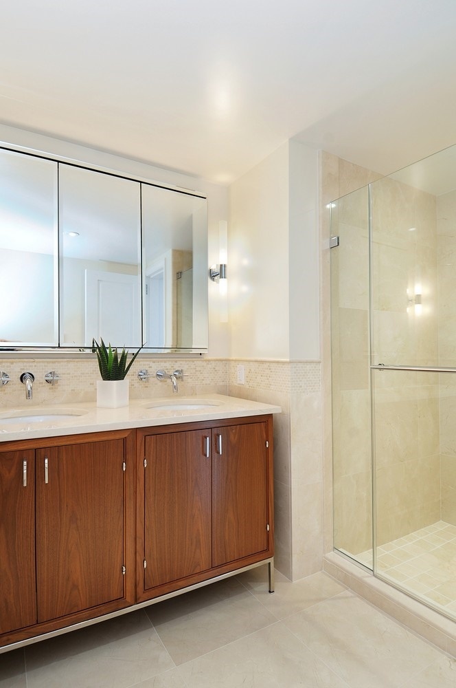 200 East 66th Street, Unit D804 Manhattan, NY 10065 - Photo 3 of 10 a bathroom with a double vanity sink and a mirror