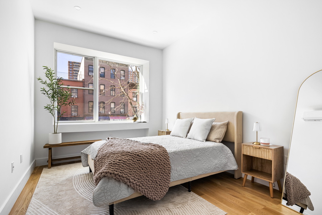 106 Graham Avenue, Unit 2A Brooklyn, NY 11206 - Photo 4 of 8 a bedroom with a large bed and a window