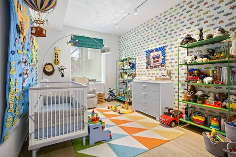a children room with toys and a book shelf