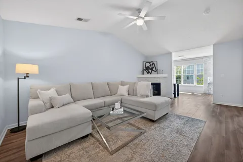 a living room with a fireplace and a large window