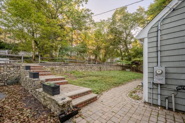 a view of backyard with sitting area