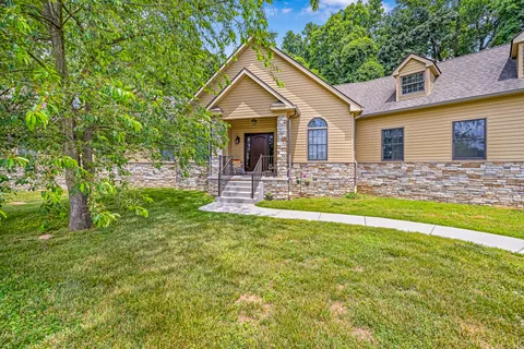 a front view of house with yard and green space