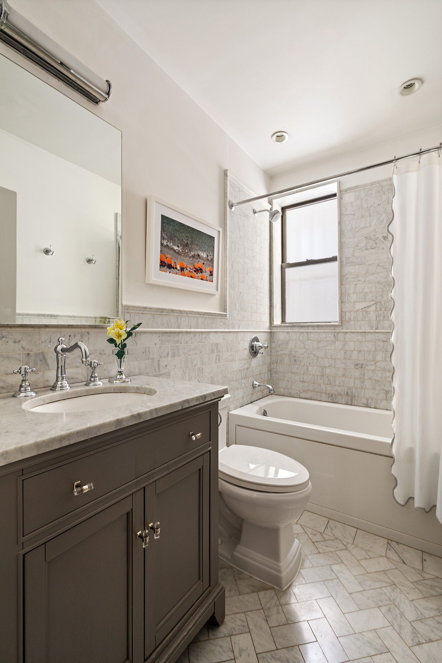 129 East 82nd Street, Unit 1C Manhattan, NY 10028 - Photo 7 of 13 a bathroom with a granite countertop toilet sink and mirror