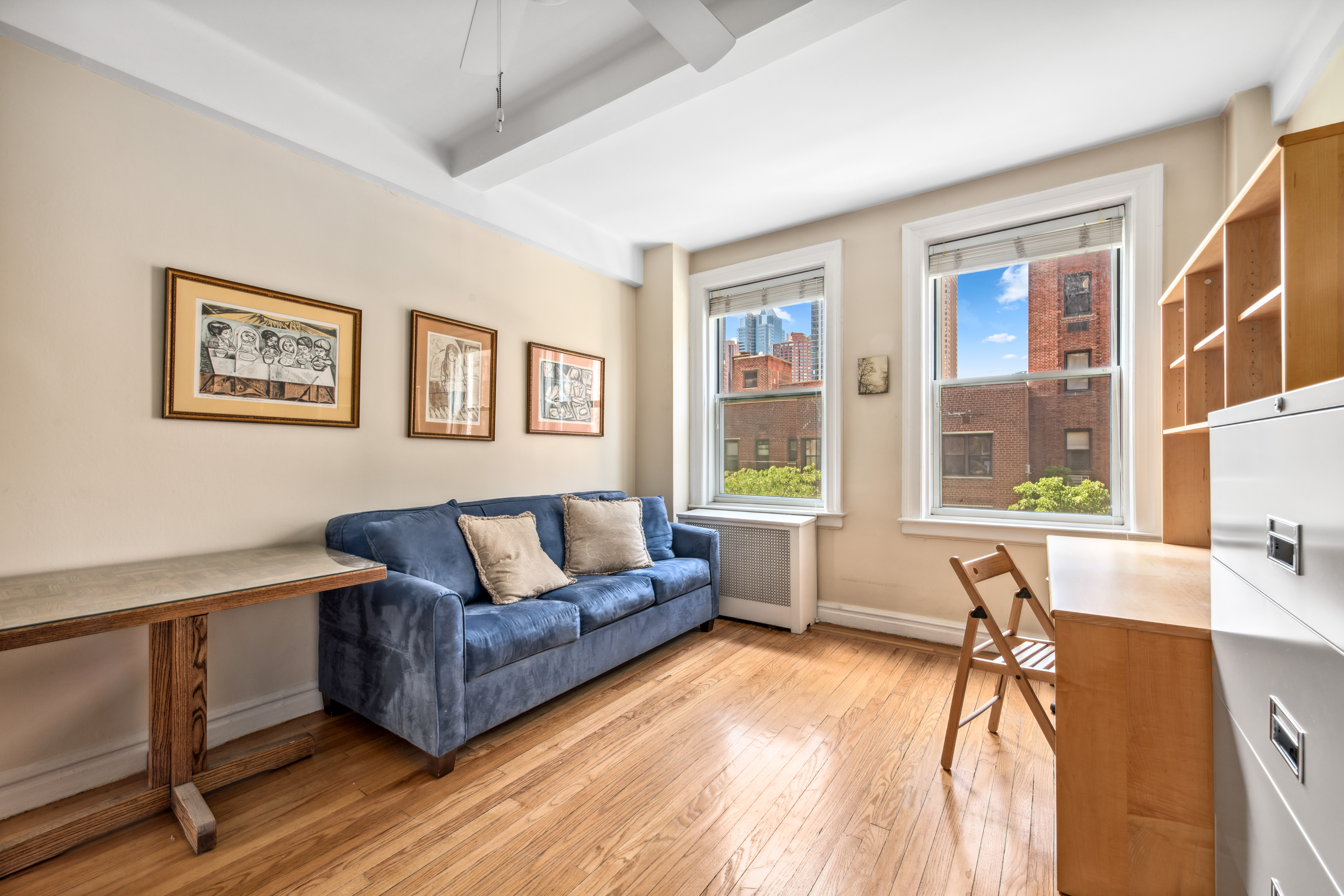 345 West 55th Street, Unit 6B Manhattan, NY 10019 - Photo 9 of 10 a living room with furniture and a window