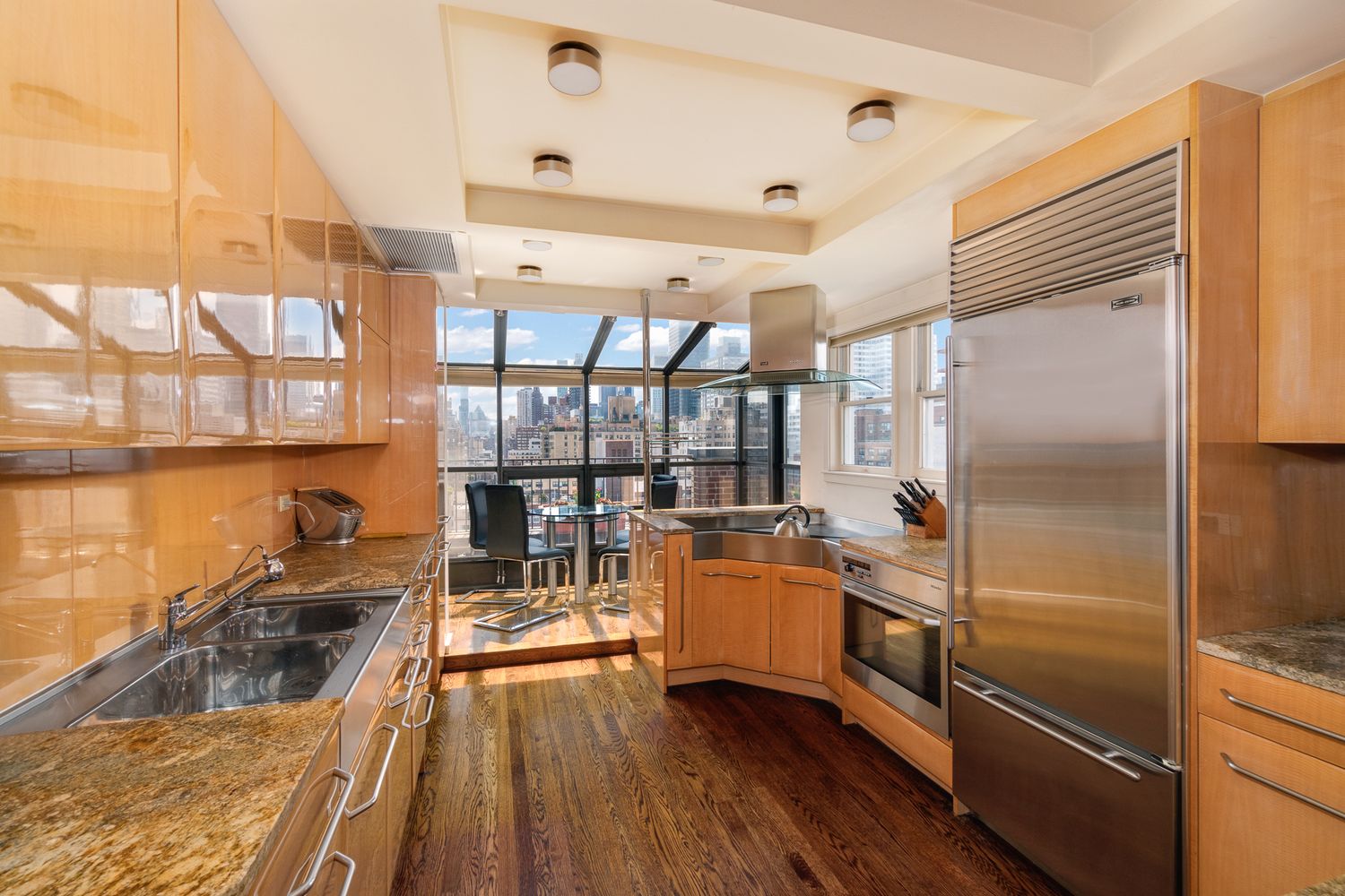 a kitchen with stainless steel appliances granite countertop a refrigerator and a sink