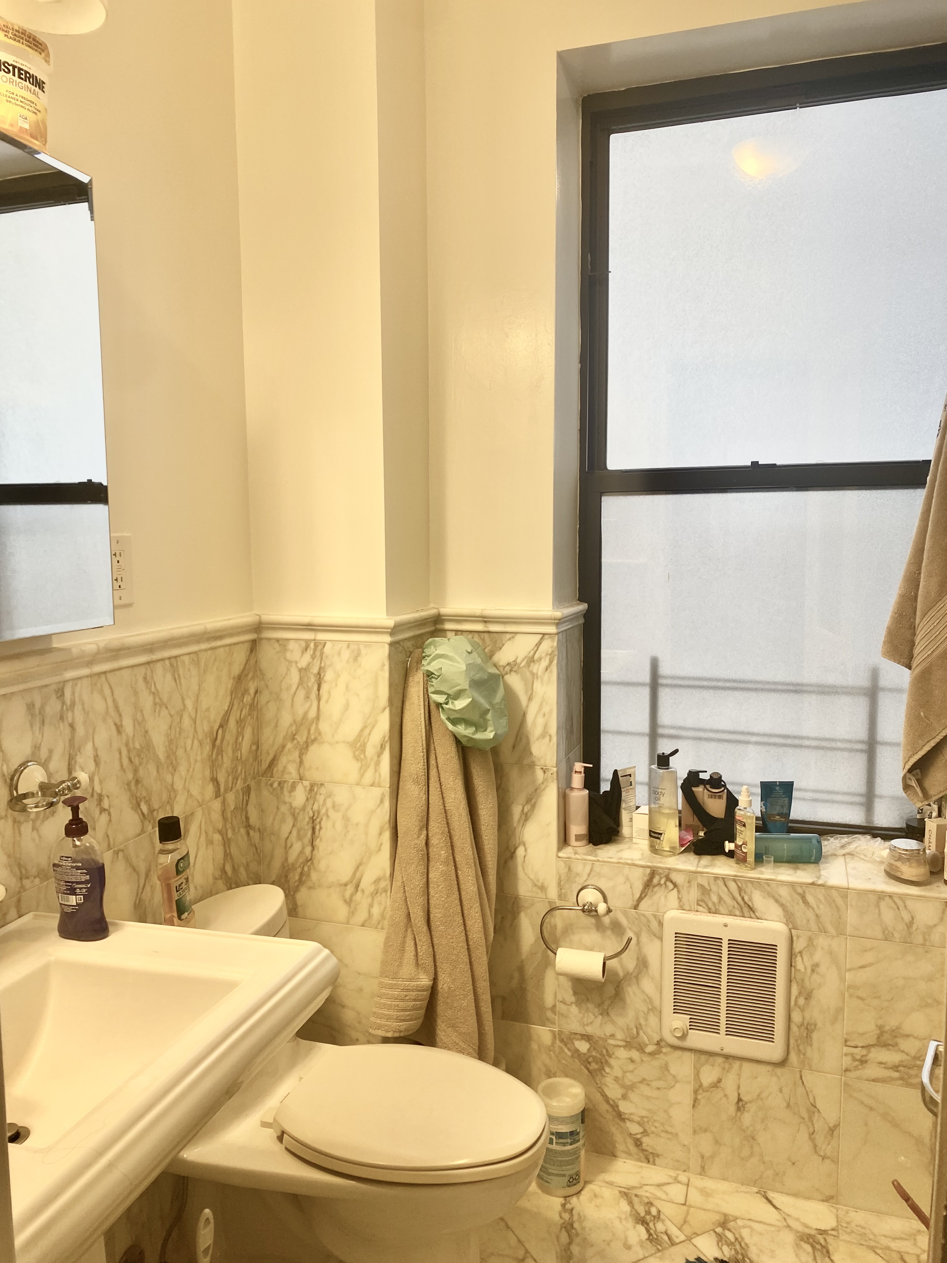 1240 Park Avenue, Unit 6B Manhattan, NY 10128 - Photo 9 of 13 a bathroom with a sink and a mirror