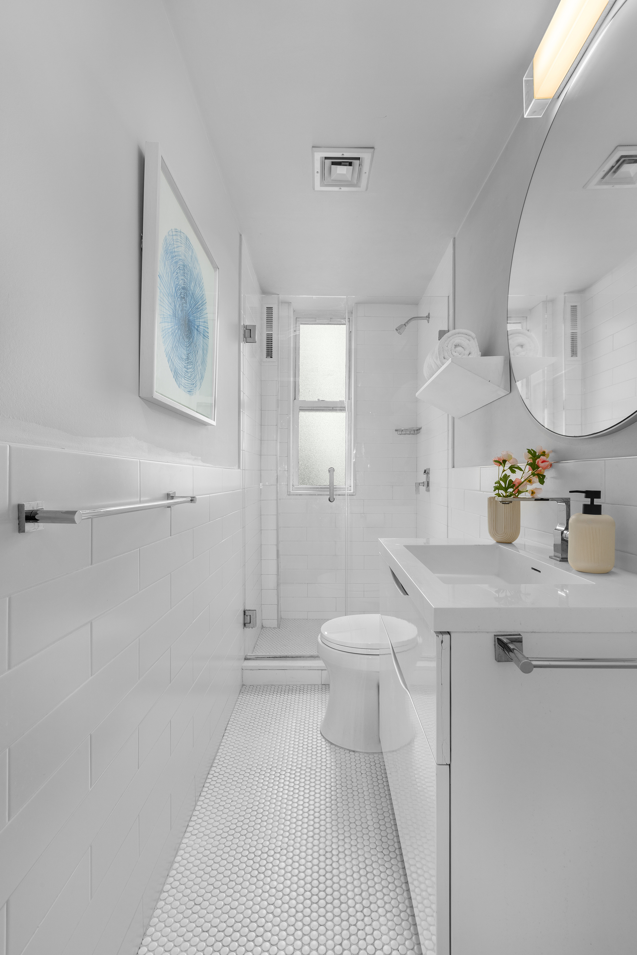 92 Perry Street, Unit 6 Manhattan, NY 10014 - Photo 8 of 10 a bathroom with a sink a toilet and a mirror