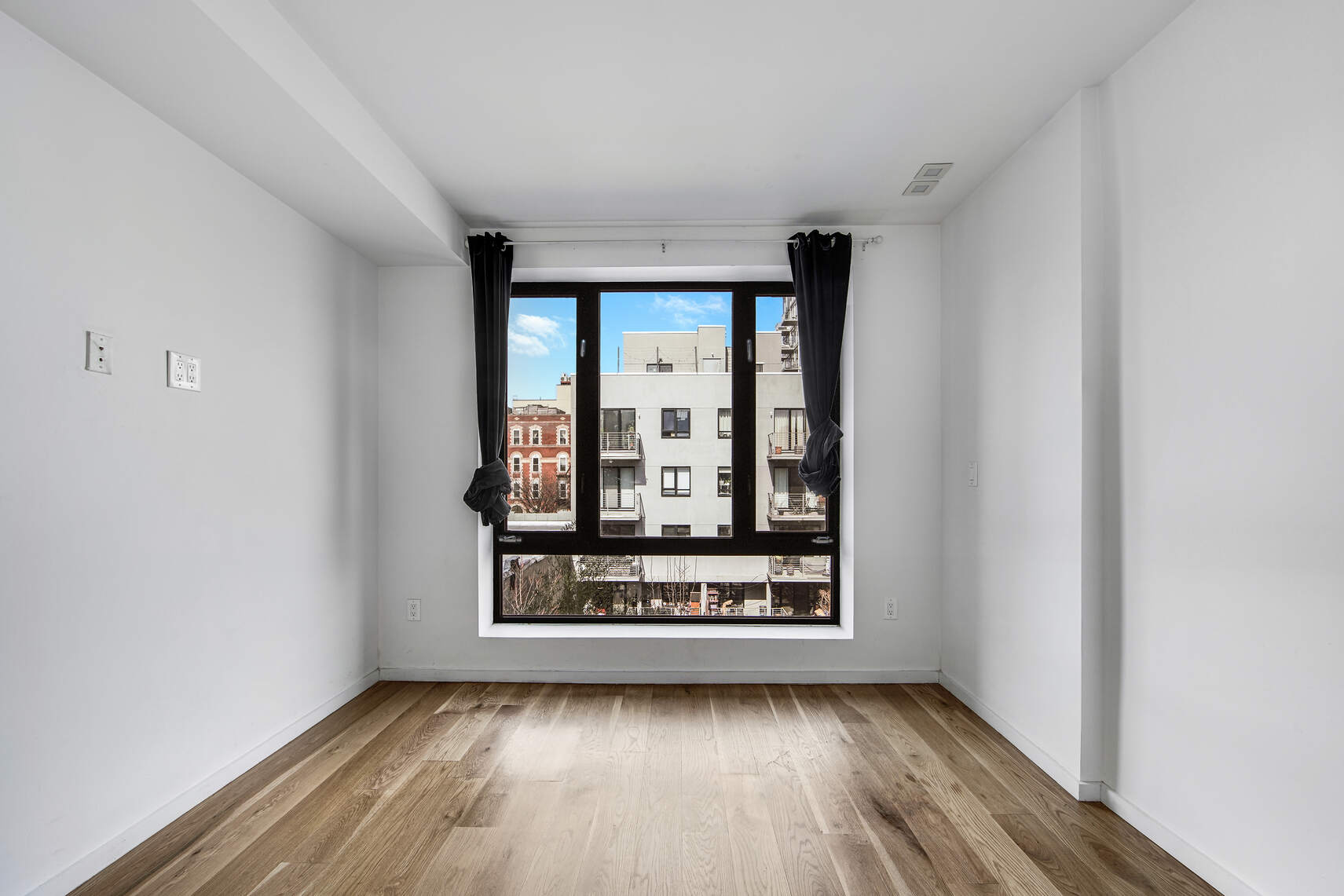 511 Lafayette Avenue, Unit 3B Brooklyn, NY 11205 - Photo 9 of 14 a view of a room with wooden floor and a window