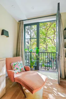 a bedroom with a bed and a large window