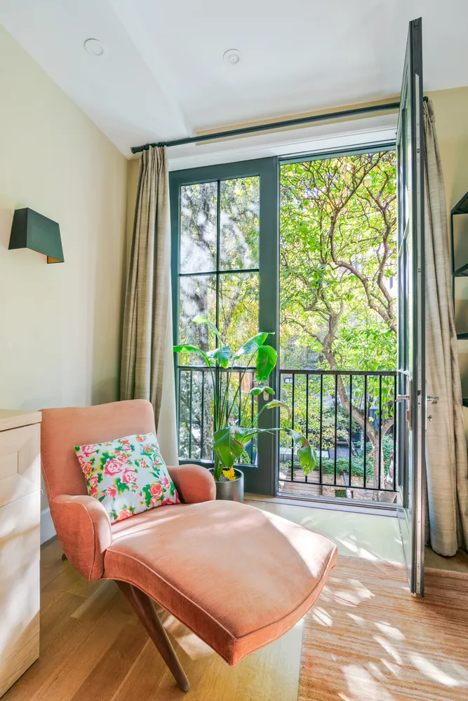 a bedroom with a bed and a large window