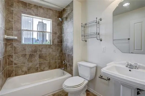 a bathroom with a sink a toilet and a bathtub