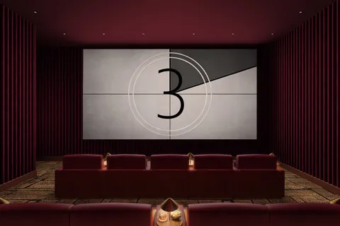 a black leather couch sitting next to a cabinet