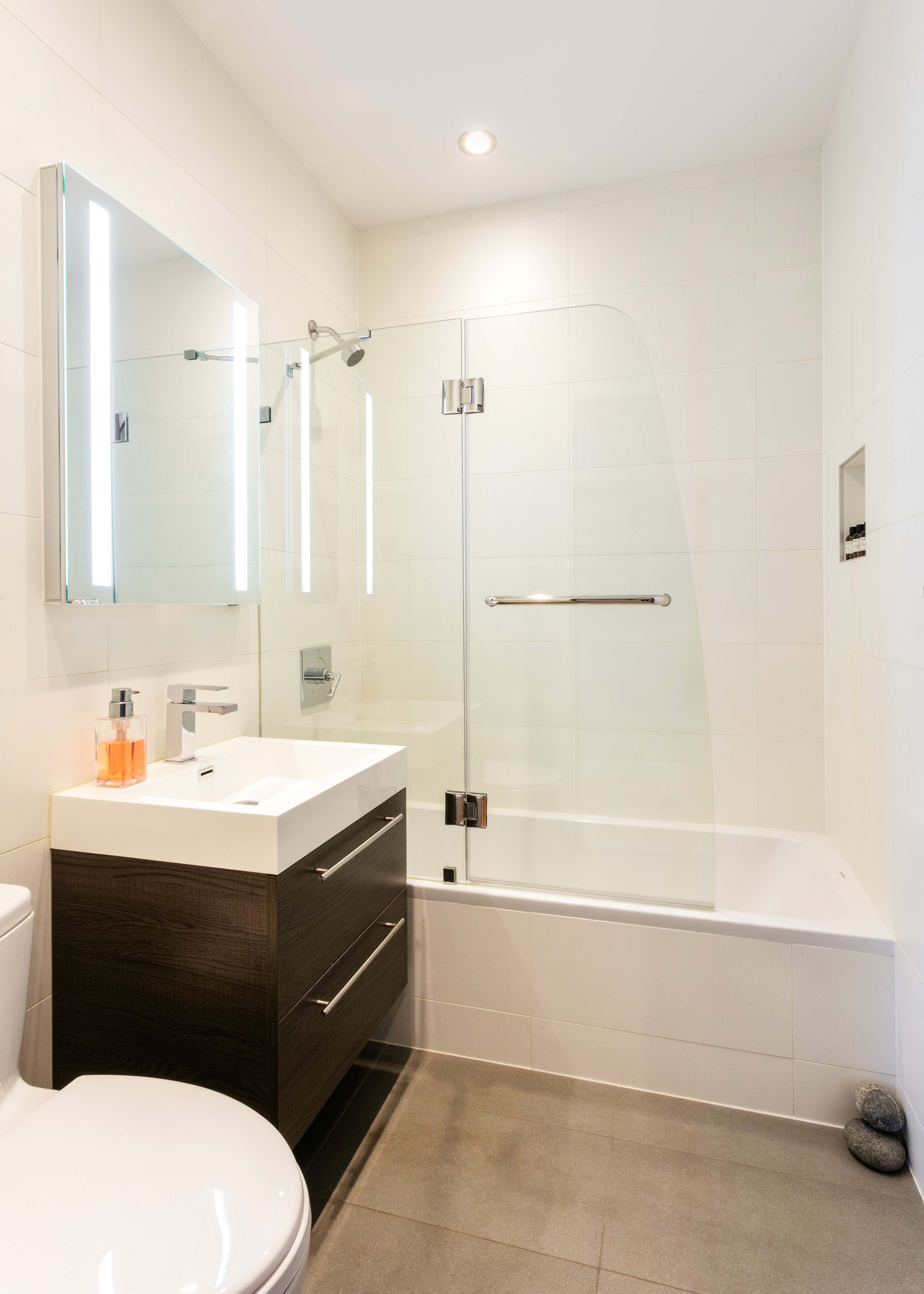60 Tiffany Place, Unit 3C Brooklyn, NY 11231 - Photo 8 of 10 a bathroom with a sink a toilet and shower